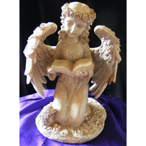 ivory kneeling angel reading a book
