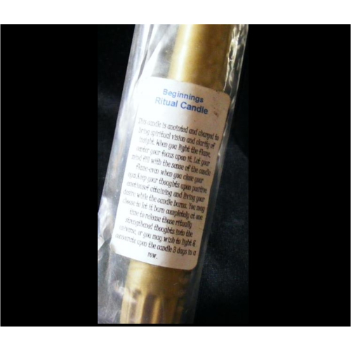 gold empowered candle for beginnings ritual close up
