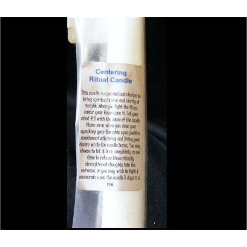 white empowered candle for centering ritual close up