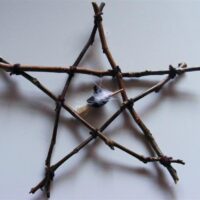 twig pentagram with witch hat on broom house protector