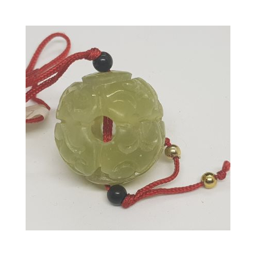 jade ball on red cord