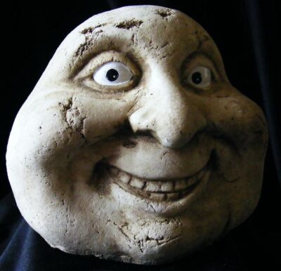 smiling stone man garden ornament