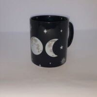 black mug with triple moon and stars design side view