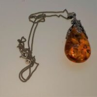 amber and silver pendant on silver chain