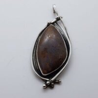 unusual shaped boulder opal pendant in fancy silver setting