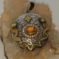 silver pendant set with citrine and peridot and brass decoration