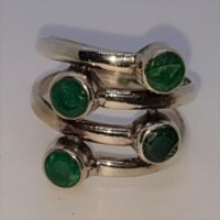 silver multi band ring with four round emeralds