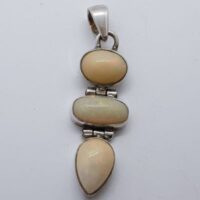 two oval and one teardrop shaped ethopian opal in silver articulated pendant