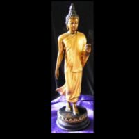 gold coloured walking buddha figure