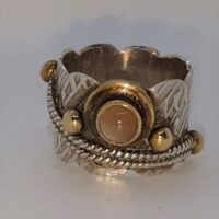 wide silver decorative ring with citrine stone and brass balls