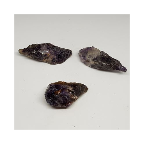 three small pieces of auralite 23