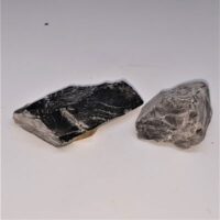 two pieces of rough black moonstone