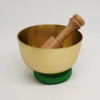 singing bowl 1 with green donut cushion and wooden beater beater in bowl stood on cushion