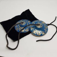 blue coloured tingsha with gold decoration on the top with pouch