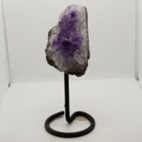 small amethyst bed with large crystals on black metal stand