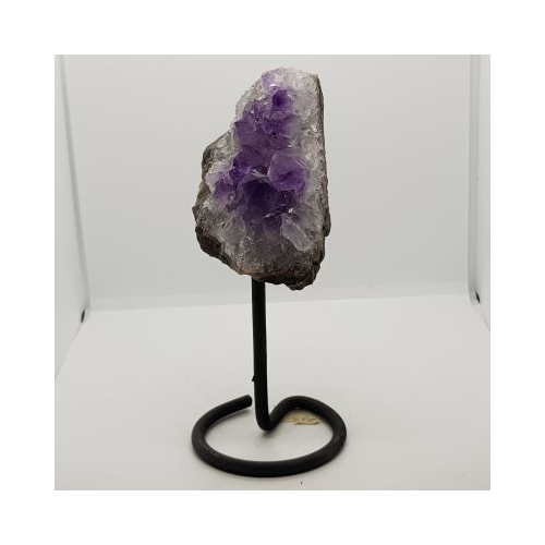 small amethyst bed with large crystals on black metal stand