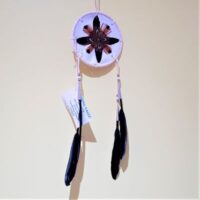 native american made white shield with feather decoration