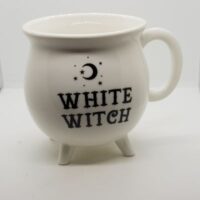 cauldron shaped white mug with black words White witch and crescent moon