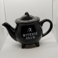 black teaport with which words witches brew and crescent moon