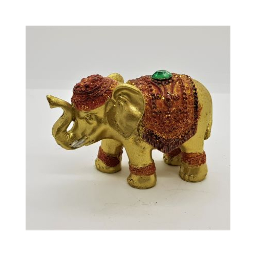 gold elephant incense holder with red coloured decoration and green jewel
