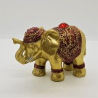 gold elephant incense holder with red coloured decoration and jewel