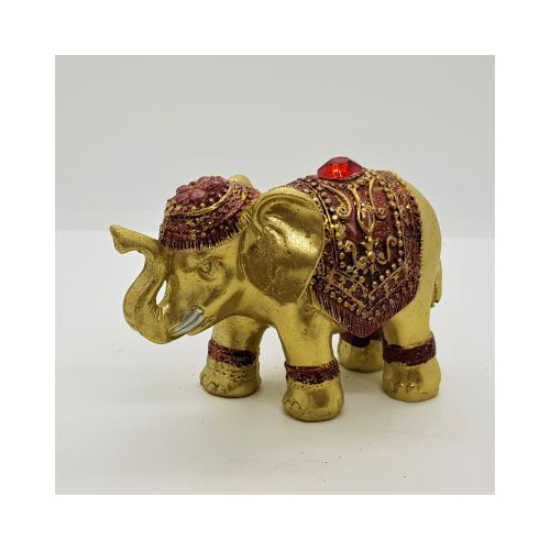 gold elephant incense holder with red coloured decoration and jewel