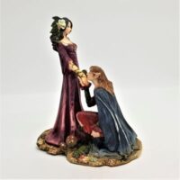 resin elf couple with girl standing and boy kneeling kissing her hand