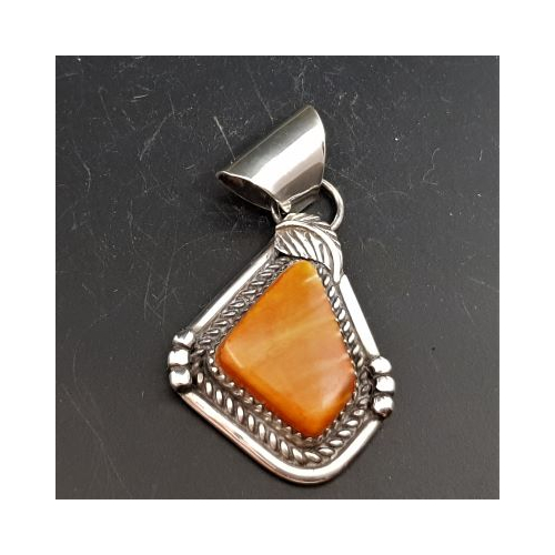 native american made silver irregular shaped pendant with patterned edge and heavy bail set with mussel shell