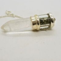 clear quartz bullet pendulum with moldovite chips above