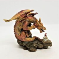 resin red and gold dragon figure with crystal ball