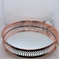 rose gold coloured edging on large mirrored candle stand