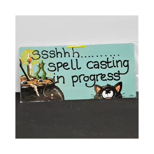 small sign with cat and candle words sshhh spell casting in progress