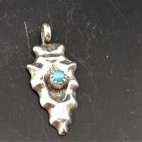 small native american made silver arrowhead with turquoise stone