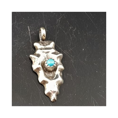 small native american made silver arrowhead with turquoise stone