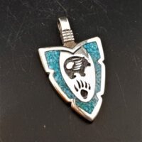 native american made silver arrowhead shaped pendant with turquoise chips and bear and bear paw design