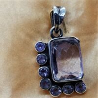 facetted rectangular amethyst with round facetted amethyst on two sides in silver