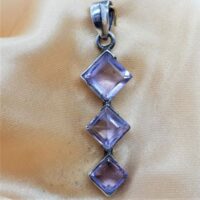 three square faceted amethyst stones in offset silver setting
