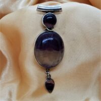 oval, round and teardrop shaped purple and clear fluorite in silver pendant