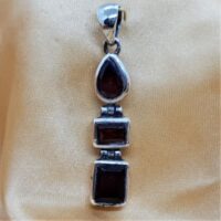 three stone garnet in silver articulated pendant