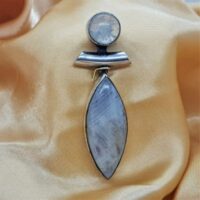 oval rainbow moonstone in silver with round rainbow moonstone at the top