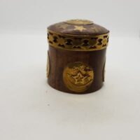small round wood and brass pot with brass trim and star design