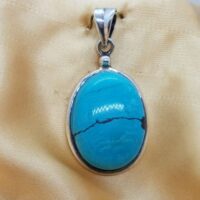 oval turquoise pendant set in silver