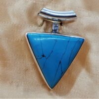 triangular turquoise pendant set in silver lose up